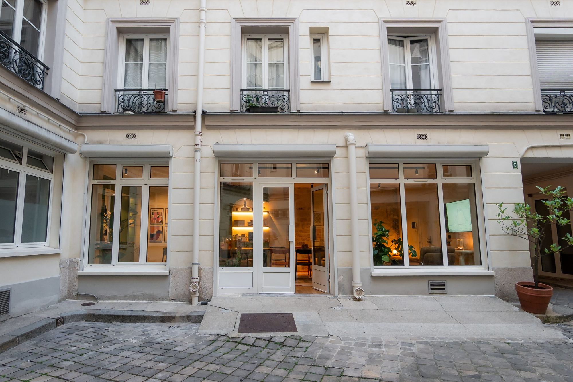 La façade sur cour et ses grandes baies vitrées